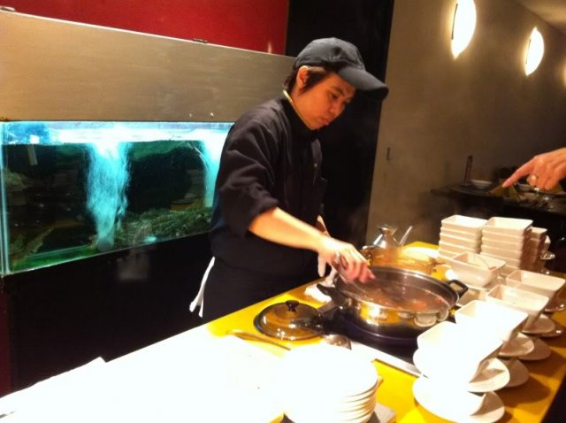 Chef at work cooking the live prawns