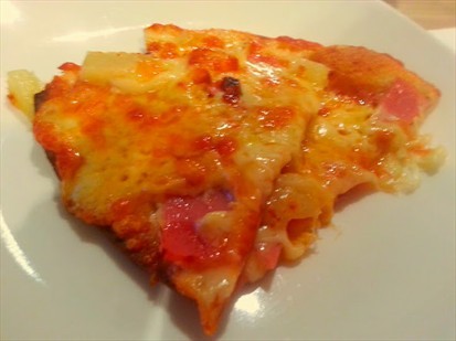A slice of the thin crust Pizza