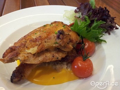 Pan roasted boneless half spring chicken with saffron rice puree, fricassee of cabbage & leeks, roasted cherry tomato