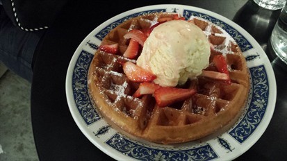 Waffle with vanilla ice cream and strawberries