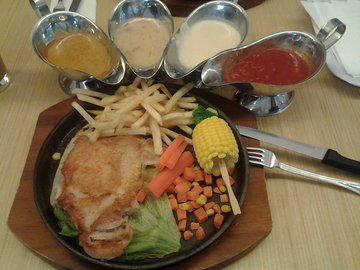 Grilled Chicken Chop in hot plate with mushroom sauce