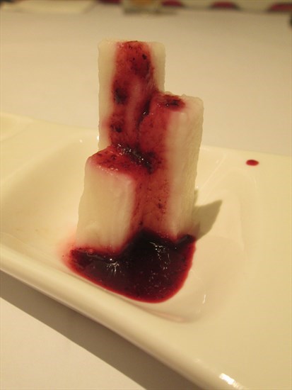 poached Japanese yuca root drizzled with a blueberry coulis