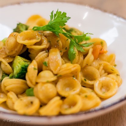 Ear-shaped pasta with anchovies, broccoli and cherry tomatoes.