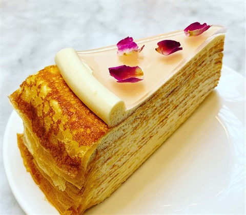 Handmade crêpe layered with rose-flavoured pastry cream, garnished with sweet rose jelly & edible rose petals.