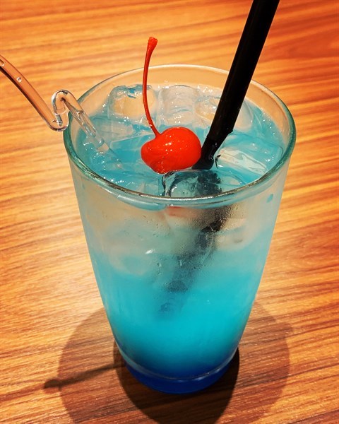 With lime juice, blue curacao & Sprite.
