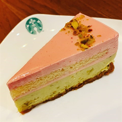 Creamy pistachio cheesecake with velvety berry mousse atop a crumbly biscuit base, crowned with pistachio nuts.