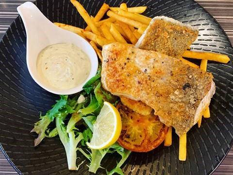 Pan-fried seabass with rich tartar sauce, served with grilled tomato, fries & salad with honey mustard dressing.