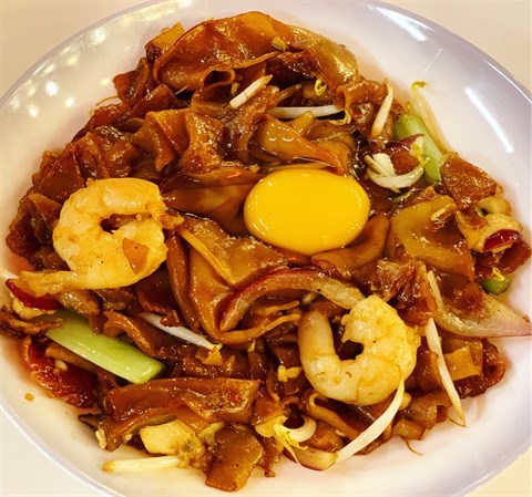 Wok-Fried seafood hor fun with Chinese sausages & moon-like “raw egg”.